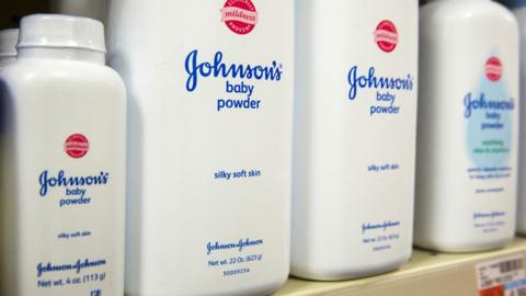 Johnson's baby powder bottles are presented on a shelf in a store in New York in 2015. The bottles have text on them reading 'silky soft skin' and 'mildness'.