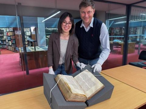 Dr Elisabetta Magnanti and Dr Mark Faulkner with the Trinity copy of Bede's Ecclesiastical History in the Library of Trinity College Dublin. 