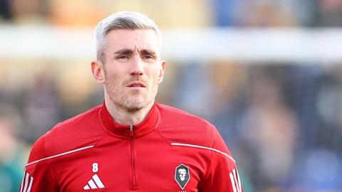 Matty Lund warms up for Salford City