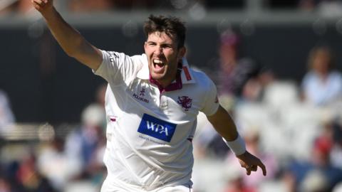 Craig Overton with arm aloft to celebrate taking a Lancashire wicket