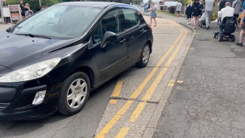 Car parks at bus stop on double yellow lines