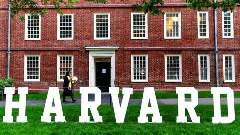 A students walks past a display on the Harvard University campus in Cambridge, Massachusetts.