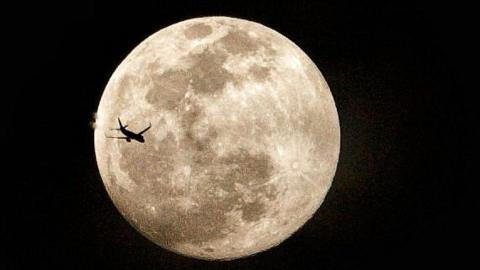 Plane in front of the Moon