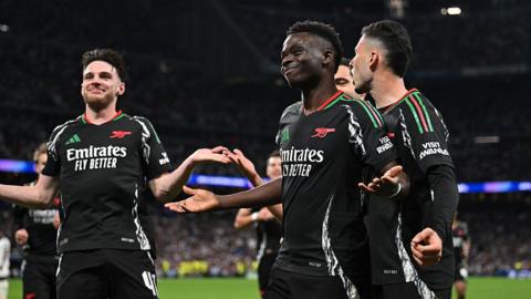 Arsenal players celebrate scoring against Real Madrid