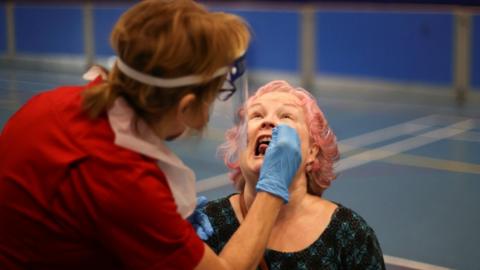 A woman in Stoke-on-Trent being tested for Covid