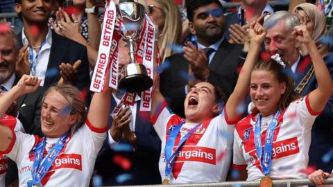 St Helens players lift the Challenge Cup