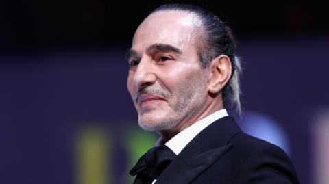 John Galliano presents the British Emerging Talent Menswear award on stage during The Fashion Awards 2017 in partnership with Swarovski at Royal Albert Hall on December 4, 2017 in London, England