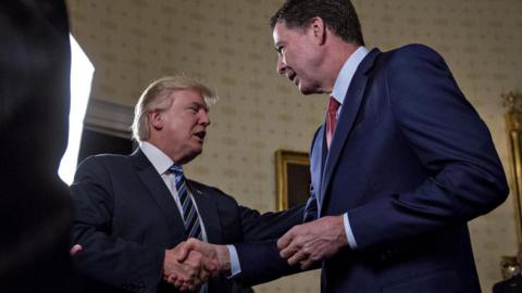 US President Donald Trump shakes hands with James Comey at the White House on January 22, 2017