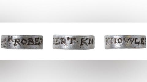 Three views of a silver hawking tag or vervel. It is engraved around its outside. The view on the left is engraved with the letters ROBER, the view in the middle has the letters BERT.KN and the view on the right has the letters KNOWLES.