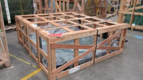 The crate that was being moved by the two workers