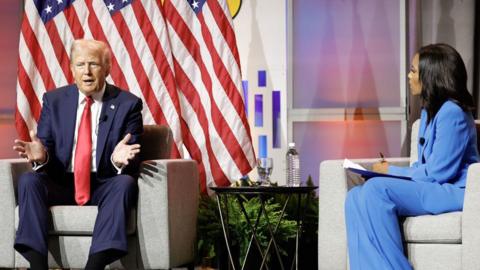 Former President Donald Trump on stage with ABC News correspondent Rachel Scott