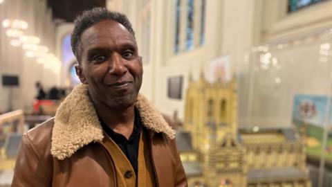 A man stands inside a church building