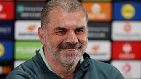 Ange Postecoglou smiling during a news conference