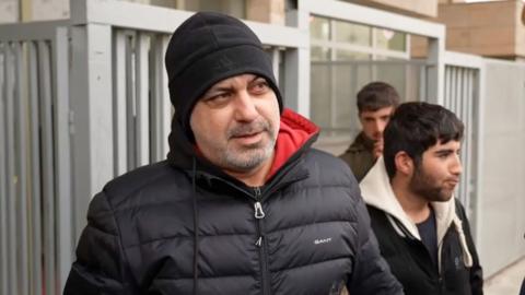 Man in black beanie and black puffer 