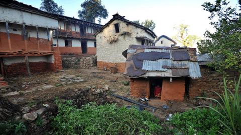 Thirteen year old Nepalese villager Sarswati Biswokarma sits inside a 'chhaupadi house' in the village of Achham, some 800km west of Kathmandu, on 23 November 2011