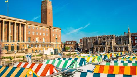 Coloured striped roofs of market stalls on Norwich market in the middle of the city.