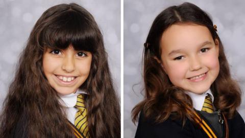 Two images of Alice Aguiar and Bebe King sit side by side. The girls are smiling and wearing their school uniform, which is a black jacket with a yellow-and-black striped tie. 