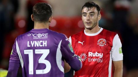 Fleetwood defender Harrison Holgate (right) 