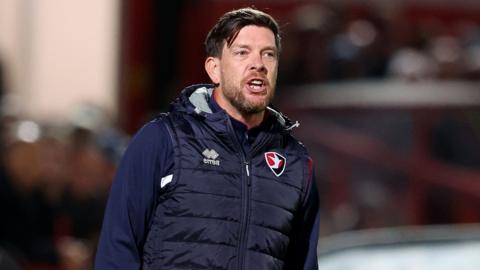 Darrell Clarke speaks to his players from the touchline during Cheltenham's defeat to Fleetwood