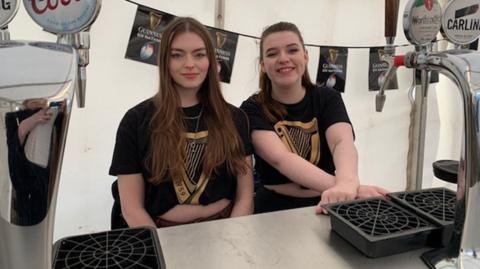 Millie and Hope behind the bar at Cheltenham Festival