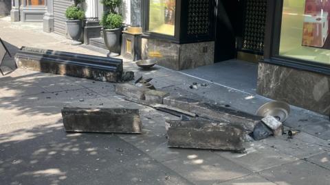 Masonry on ground outside Wellington Place business