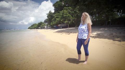 Lis Cashin looks out to see from a sandy beach