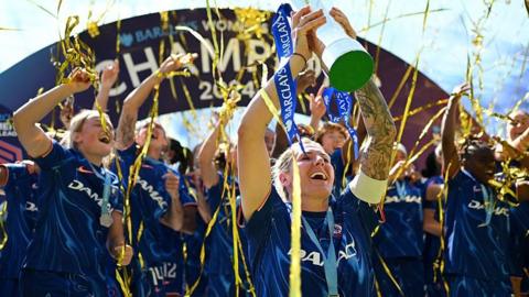 Millie Bright lifiting trophy