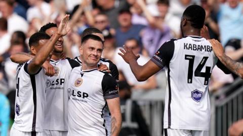Bromley players celebrate taking the lead against Walsall