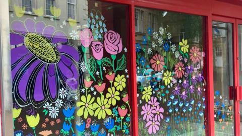 Window display of drawn on flowers