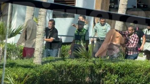 Undercover police officers detaining suspected members of a cartel at a luxury hotel in Mexico.  