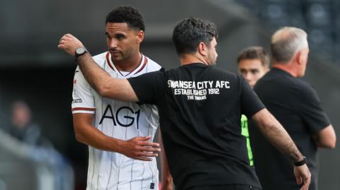 Ben Cabango and Vitor Matos on the touchline