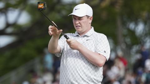 Robert MacIntyre sizes up a putt in Hawaii