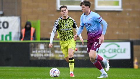 Gateshead midfielder Josh Home is put under pressure by an opponent
