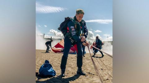 RAF Sgt Marcus Shields finishing his parachute jump