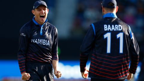 Gerhard Erasmus of Namibia celebrates a catch by Stephan Baard during the ICC Men's T20 World Cup match against Sri Lanka