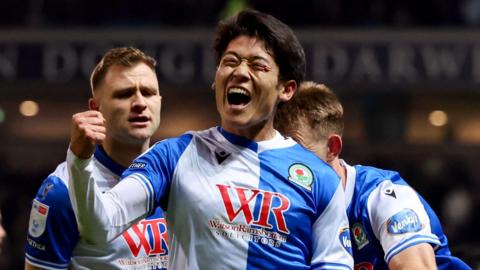 Yuki Ohashi, wearing Blackburn's blue and white home shirt, punches his fist in celebration and has his mouth open shouting after scoring against Preston North End in February
