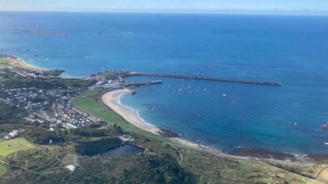 An aerial photo that shows Alderney harbour on a sunny day.