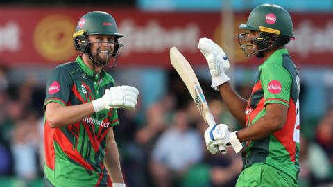 Leicestershire batter Sol Budinger (left) celebrates his 50 with Rishi Patel