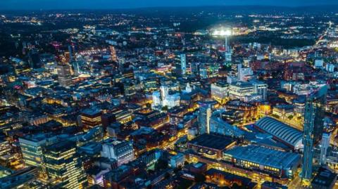 Aerial view of Manchester at night. The Beetham Tower is on the right.