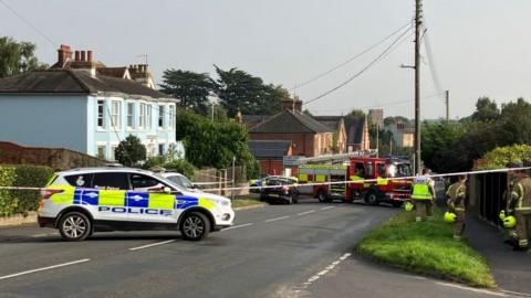 A police cordon is in place around a fallen electrical wire