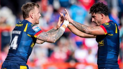 Tom Johnstone and Arthur Romano celebrate Johnstone's try