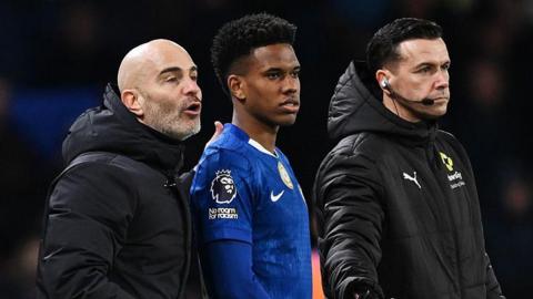 Chelsea winger Estevao Willian waiting to come on to the pitch as a substitute while standing next to manager Enzo Maresca