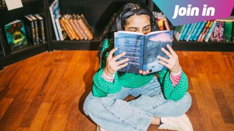 girls reading on library floor