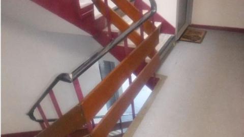 Orange horizontal guarding on a metal staircase. 