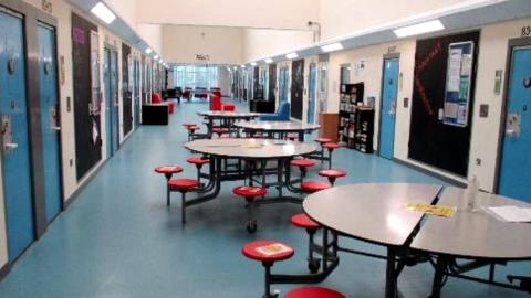 Tables in a corridor inside HMYOI Cookham Wood in Kent