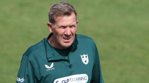 Alan Richardson wearing a green Worcestershire training top looks on