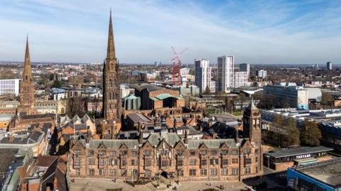 Aerial view of Coventry city center showing the ruins of the old cathedral, the new cathedral and the Council House.