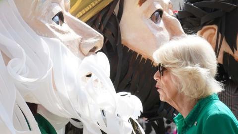 Queen Camilla meet characters representing legendary and historical characters associated with Armagh during a visit to Market Theatre Square, Armagh, Co Armagh as part of a two day visit to Northern Ireland. May 25, 2023.