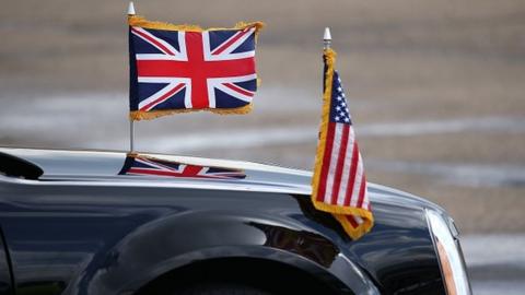 Car with UK and US flags