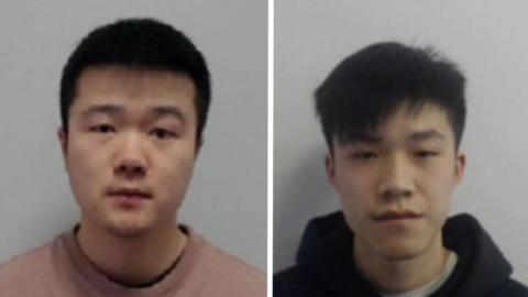 Two men are looking into the camera. One is wearing a dark hoodie and the other is wearing a salmon coloured top. 